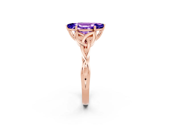 Rose gold Marquise Cut Tanzanite Solitaire Engagement Ring with Celtic Knot Band and Four-Prong Setting
