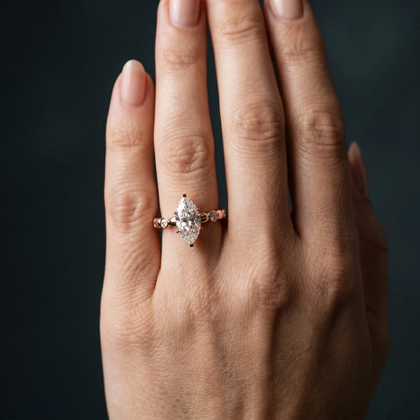 Rose gold Marquise Solitaire Bezel-Set Diamond Ring with Beaded Band and Four-Prong Setting