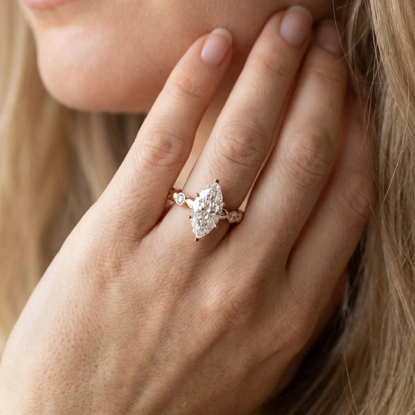 Rose gold Marquise Solitaire Bezel-Set Diamond Ring with Beaded Band and Four-Prong Setting