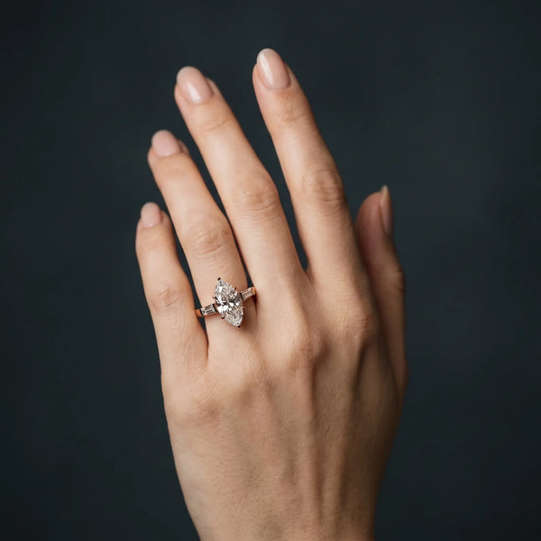 Rose gold Marquise Solitaire with Tapered Baguette Side Stones on a Classic Band with Four-Prong Setting