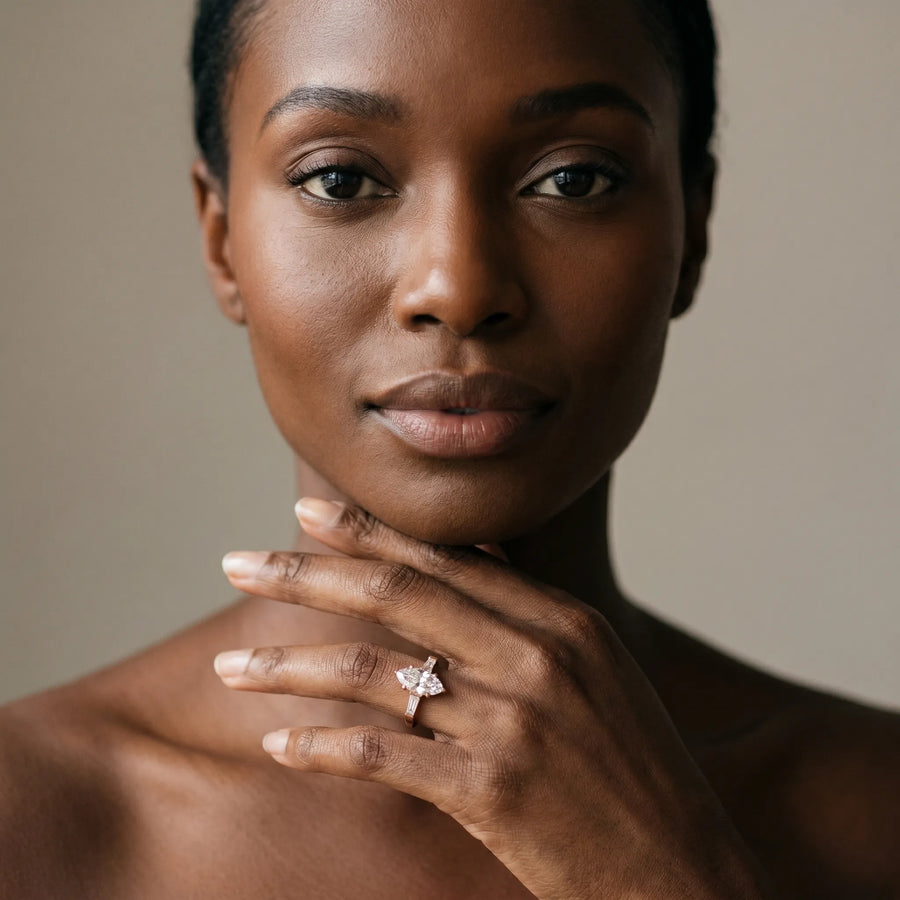 Rose gold Marquise Solitaire with Tapered Baguette Side Stones on a Classic Band with Four-Prong Setting