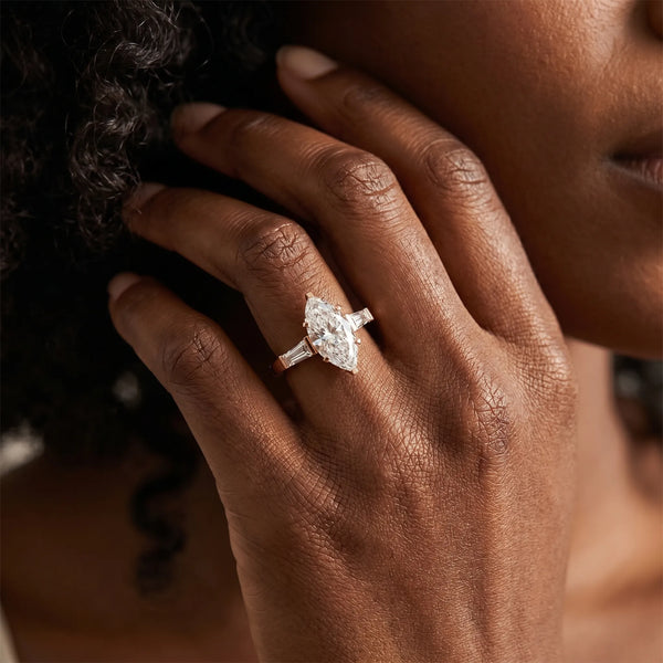 Rose gold Marquise Solitaire with Tapered Baguette Side Stones on a Classic Band with Four-Prong Setting