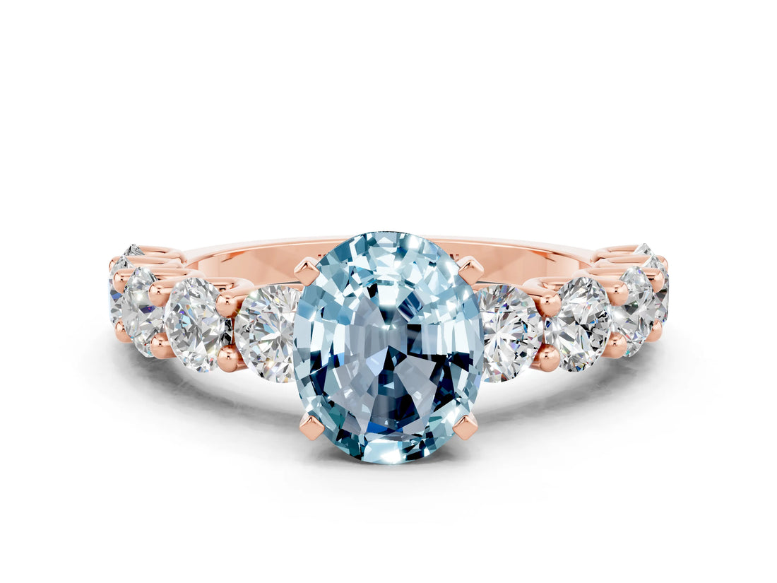 Rose gold Oval Cut Aquamarine Prong Setting with Side Stones on a Pave Band