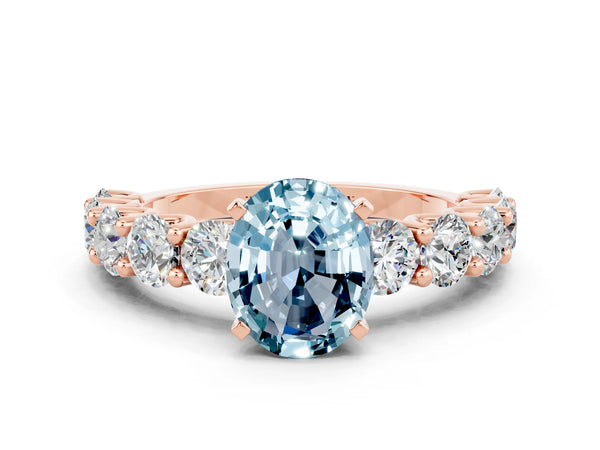 Rose gold Oval Cut Aquamarine Prong Setting with Side Stones on a Pave Band
