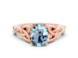 Rose gold Oval Cut Aquamarine Solitaire Engagement Ring with Celtic Knot Band and Four-Prong Setting