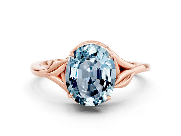 Rose gold Oval Cut Aquamarine Solitaire Ring with Twist Band and Four-Prong Setting