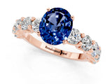 Rose gold Oval Cut Blue Sapphire Prong Setting with Side Stones on a Pave Band_1
