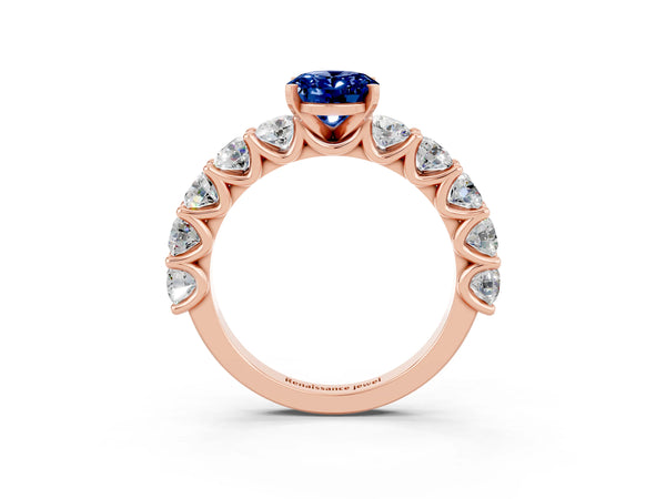 Rose gold Oval Cut Blue Sapphire Prong Setting with Side Stones on a Pave Band