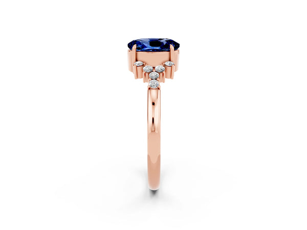 Rose gold Oval Cut Blue Sapphire Ring with Side Stones and Four-Prong Setting