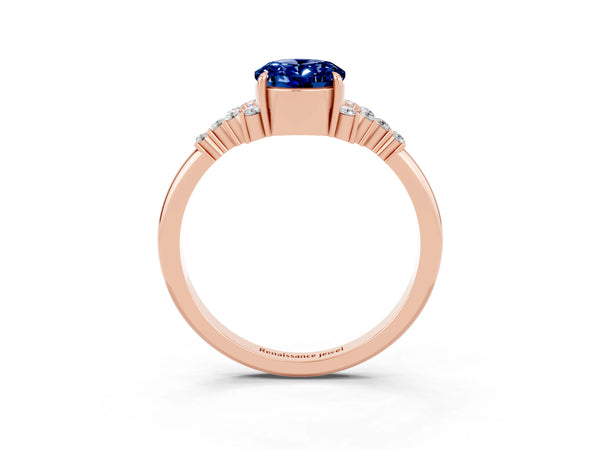 Rose gold Oval Cut Blue Sapphire Ring with Side Stones and Four-Prong Setting