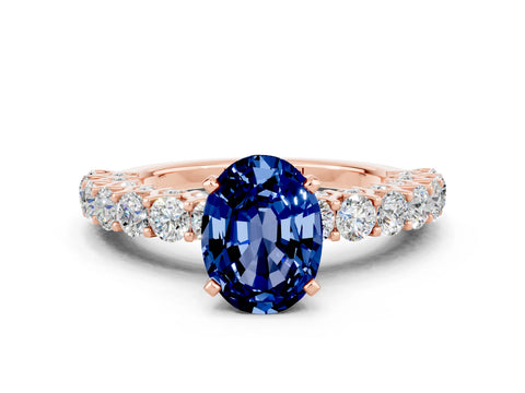 Rose gold Oval Cut Blue Sapphire Solitaire Ring with Shared Prong Pavé Band and Four-Prong Setting