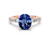Rose gold Oval Cut Blue Sapphire Solitaire with Side Baguettes and Channel Set Band