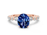 Rose gold Oval Cut Blue Sapphire Solitaire with Side Stones on a Pavé Band and Four-Prong Setting
