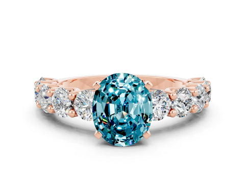 Rose gold Oval Cut Blue Topaz Prong Setting with Side Stones on a Pave Band