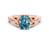 Rose gold Oval Cut Blue Topaz Solitaire Engagement Ring with Celtic Knot Band and Four-Prong Setting