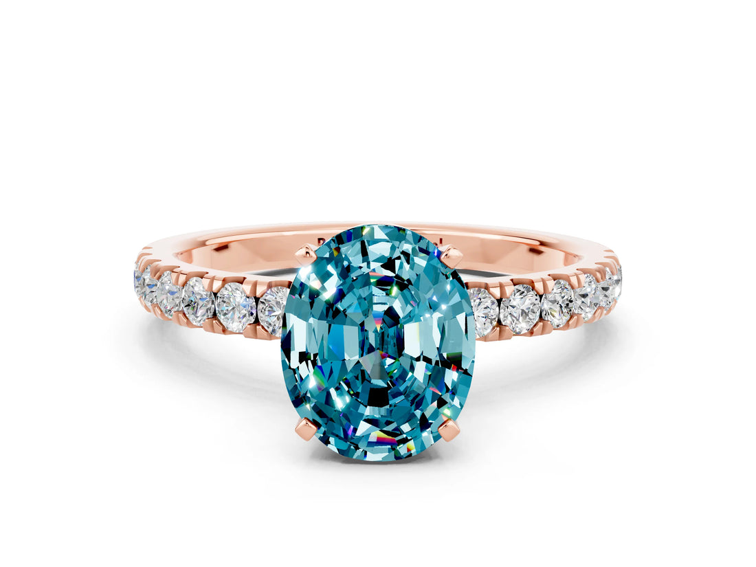 Rose gold Oval Cut Blue Topaz Solitaire Ring with Pavé Accents and Four-Prong Setting