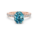 Rose gold Oval Cut Blue Topaz Solitaire Ring with Pavé Accents and Four-Prong Setting