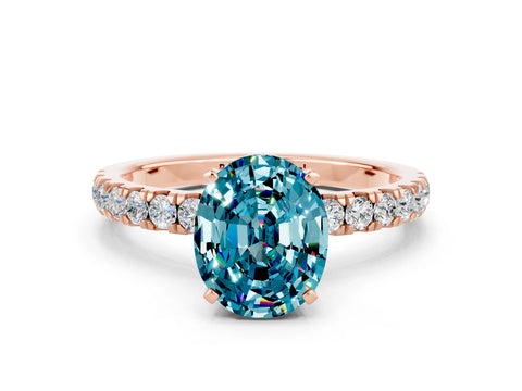Rose gold Oval Cut Blue Topaz Solitaire Ring with Pavé Accents and Four-Prong Setting