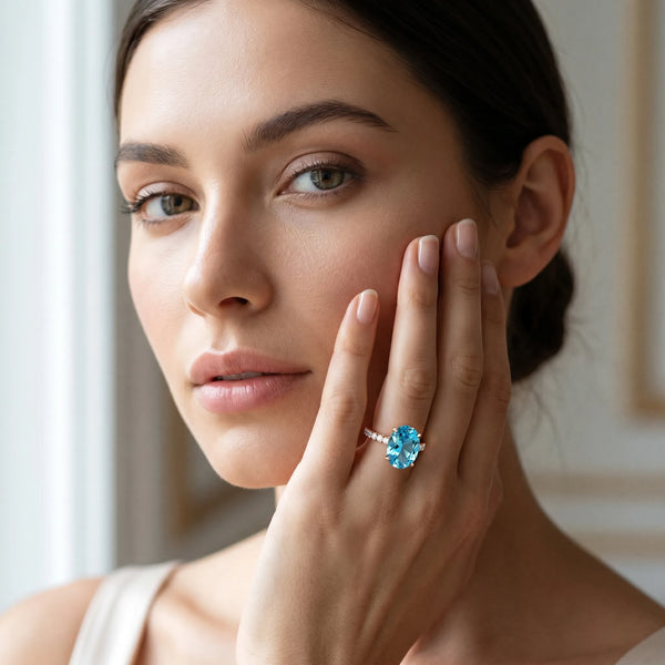 Rose gold Oval Cut Blue Topaz Solitaire Ring with Round  Pavé Band and Four-Prong Setting