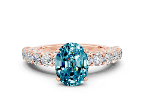 Rose gold Oval Cut Blue Topaz Solitaire Ring with Shared Prong Pavé Band and Four-Prong Setting