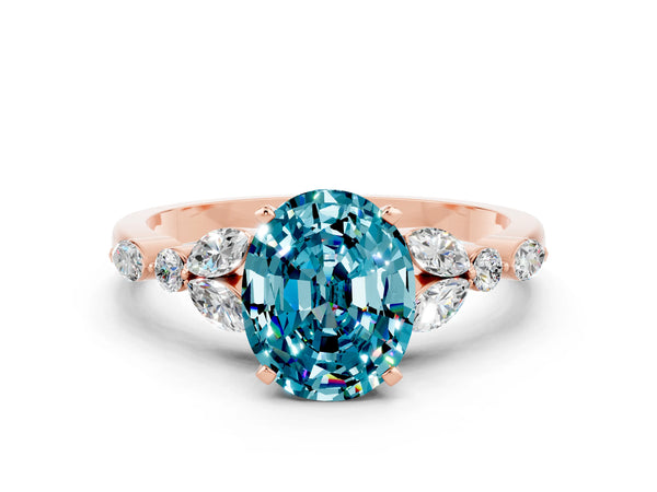 Rose gold Oval Cut Blue Topaz Solitaire Ring with Side Stones and Four-Prong Setting