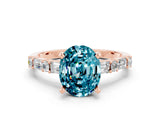Rose gold Oval Cut Blue Topaz Solitaire with Side Baguettes and Channel Set Band