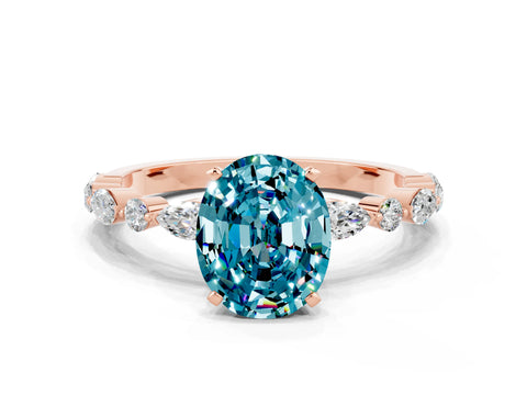 Rose gold Oval Cut Blue Topaz Solitaire with Side Stones on a Pavé Band and Four-Prong Setting