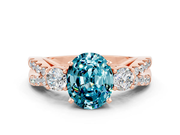 Rose gold Oval Cut Blue Topaz Three-Stone Ring with Pavé Split Shank and Four-Prong Setting