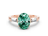 Rose gold Oval Cut Cut Diamond Ring with Tapered Baguette Side Stones in Four-Prong Setting