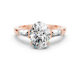 Rose gold Oval Cut Cut Diamond Ring with Tapered Baguette Side Stones in Four-Prong Setting
