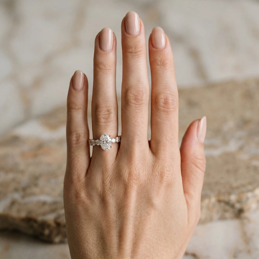 Rose gold Oval Cut Diamond Prong Setting with Side Stones on a Pave Band