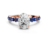 Rose gold Oval Cut Diamond Side Stone Solitaire Ring with Round with Blue Sapphire side stone and Four-Prong Setting