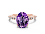 Rose gold Oval Cut Diamond Solitaire Ring with Four-Prong Setting and Pavé Band