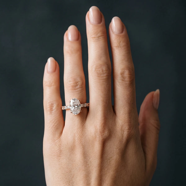 Rose gold Oval Cut Diamond Solitaire with Side Baguettes and Channel Set Band