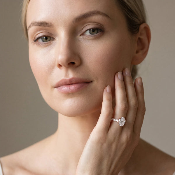 Rose gold Oval Cut Diamond Solitaire with Side Baguettes and Channel Set Band