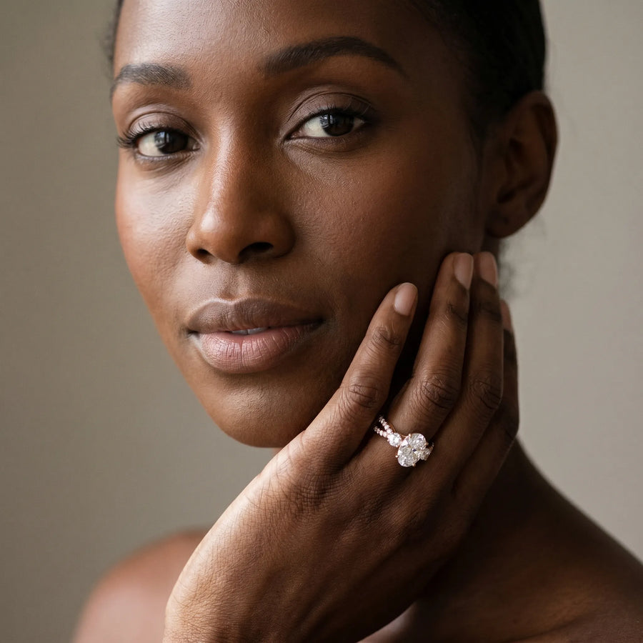Rose gold Oval Cut Diamond Three-Stone Ring with Pavé Split Shank and Four-Prong Setting