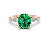 Rose gold Oval Cut Emerald Solitaire with Side Baguettes and Channel Set Band