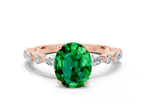 Rose gold Oval Cut Emerald Solitaire with Side Stones on a Pavé Band and Four-Prong Setting