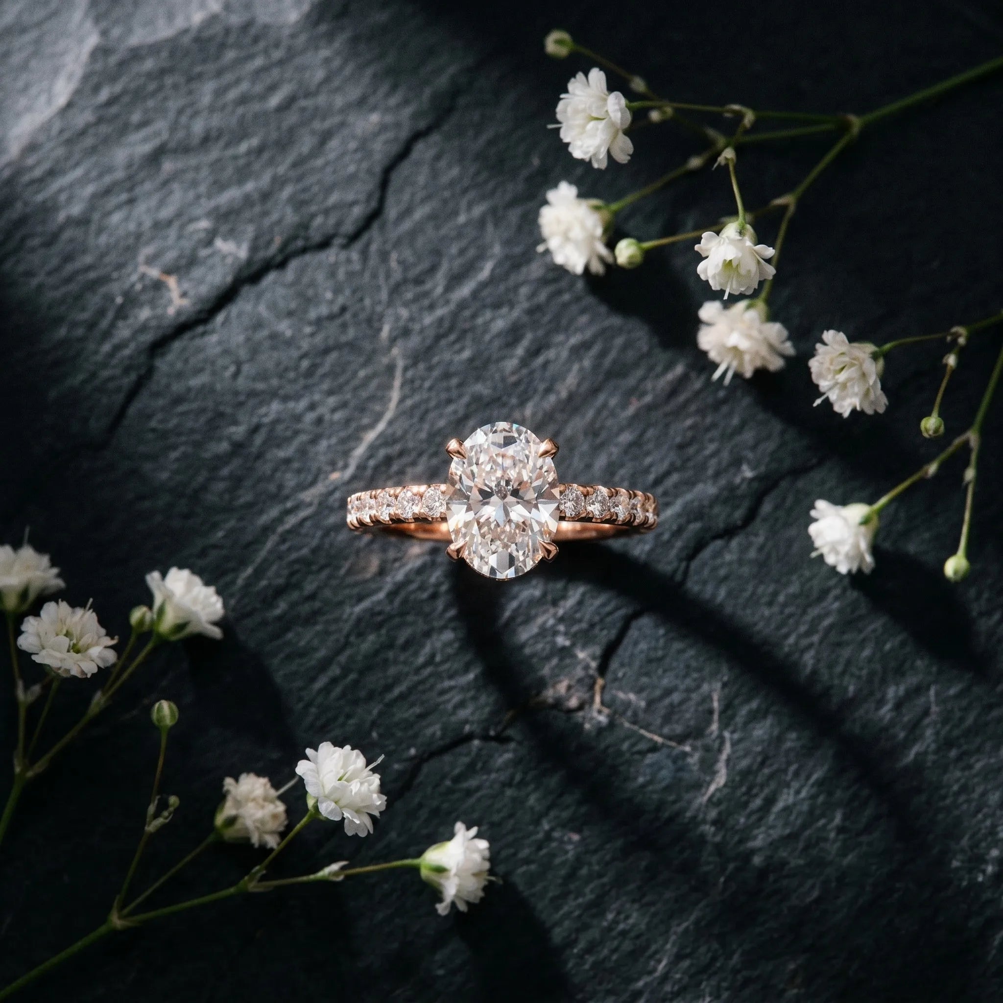 Rose gold Oval Cut Moissanite Solitaire Ring with Round  Pavé Band and Four-Prong Setting