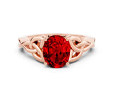 Rose gold Oval Cut Ruby Solitaire Engagement Ring with Celtic Knot Band and Four-Prong Setting