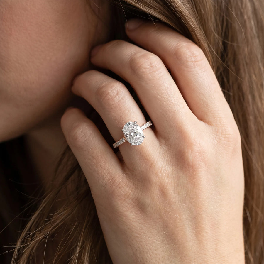 Rose gold Oval Cut Solitaire Diamond Ring with Pave Band and Four-Prong Setting