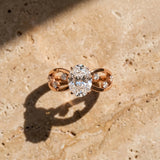 Rose gold Oval Cut Solitaire Diamond with Side Stones on Criss-Cross Band and Four-Prong Setting_16