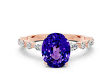 Rose gold Oval Cut Tanzanite Solitaire with Side Stones on a Pavé Band and Four-Prong Setting