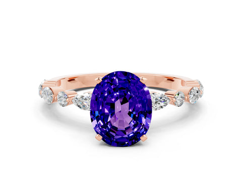 Rose gold Oval Cut Tanzanite Solitaire with Side Stones on a Pavé Band and Four-Prong Setting