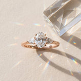 Rose gold Oval Cut Three-Stone Diamond Ring with Pear Side Stones on a Classic Solitaire Band with Prong Setting_9