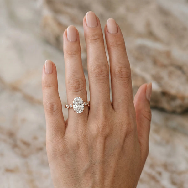 Rose gold Oval Solitaire Bezel Accent Diamond Engagement Ring with Beaded Band and Four-Prong Setting