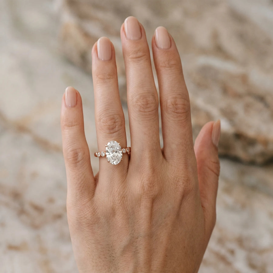 Rose gold Oval Solitaire Bezel Accent Diamond Engagement Ring with Beaded Band and Four-Prong Setting