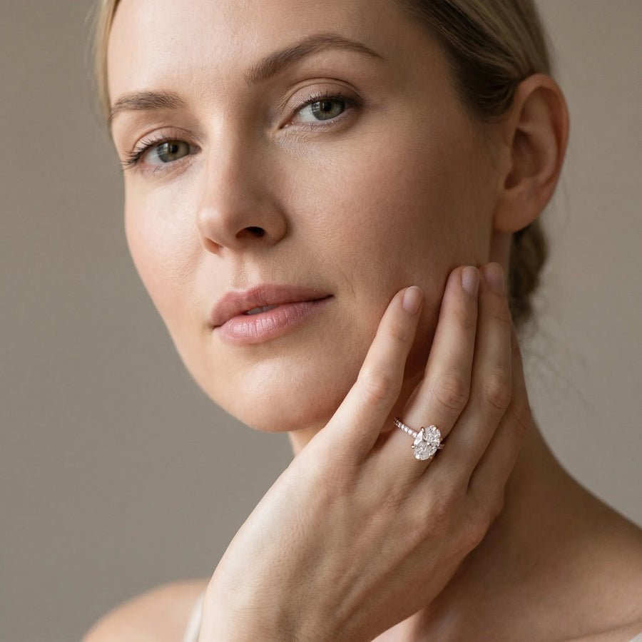 Rose gold Oval Solitaire Diamond Engagement Ring with Pave Band and Six-Prong Setting