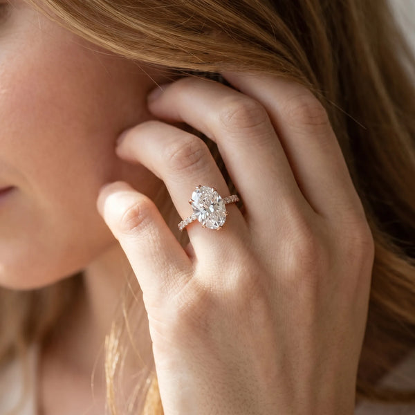 Rose gold Oval Solitaire Diamond Engagement Ring with Pave Band and Six-Prong Setting
