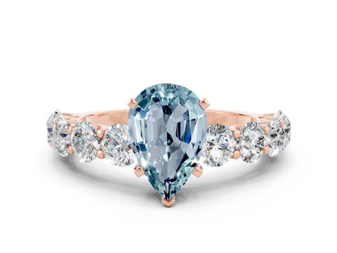 Rose gold Pear Cut Aquamarine Prong Setting with Side Stones on a Pave Band